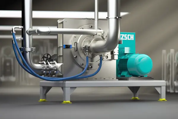 NETZSCH industrial grinding and dispersing machine with stainless steel piping for chemical and mineral processing.
